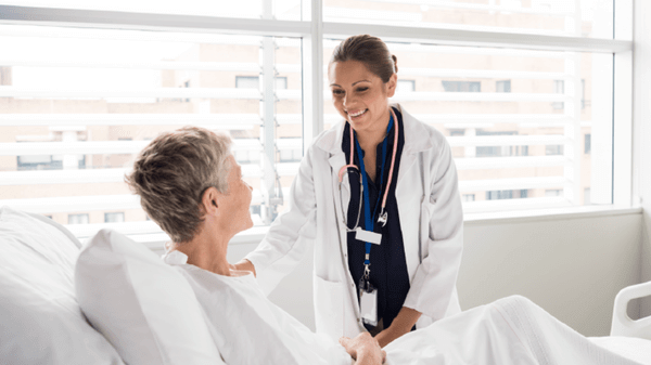 Worker and patient in a hospital bed