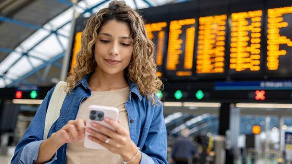 Image of woman at airport checking phone