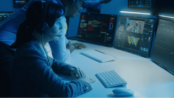 Woman at computer desk with head set in