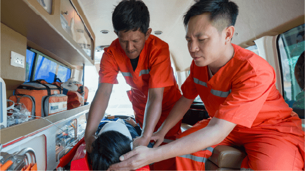 Medics helping patient inside an air ambulance