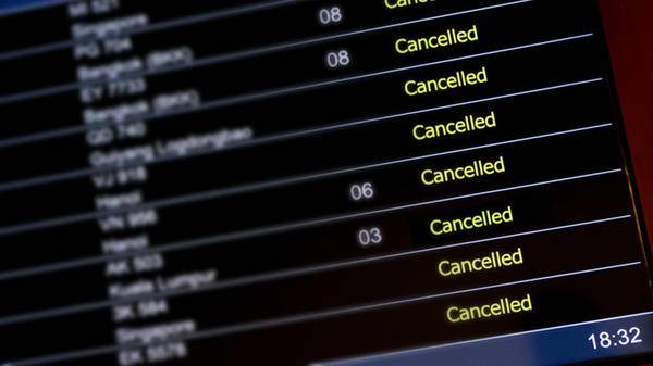 Image of flight schedule with cancelled flights at airport