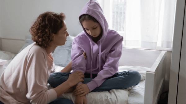 A mum supporting her sad daughter