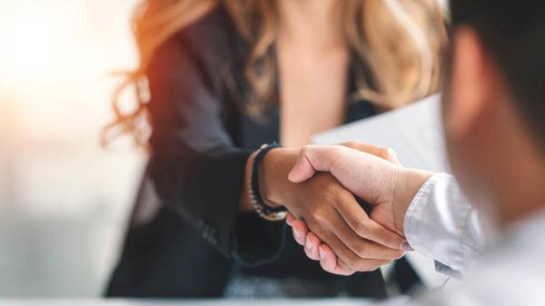 Businesswoman handshake and business people