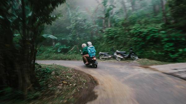 Man and woman on scooter in jungles