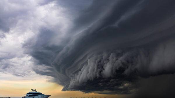 Luxury yacht under a scary looking tropical "shelf cloud"