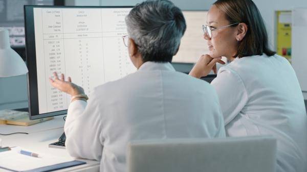 Science, hospital and women on computer for research, medical report and data analytics in laboratory