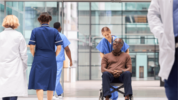 Doctor pushing man in a wheelchair