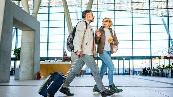 Mature couple of passengers at the train station