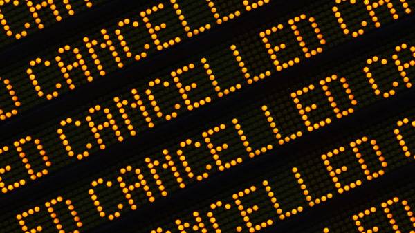 A Close Up Of The Word Cancelled Repeated Multiple Times On A Sign At A Station Or Airport