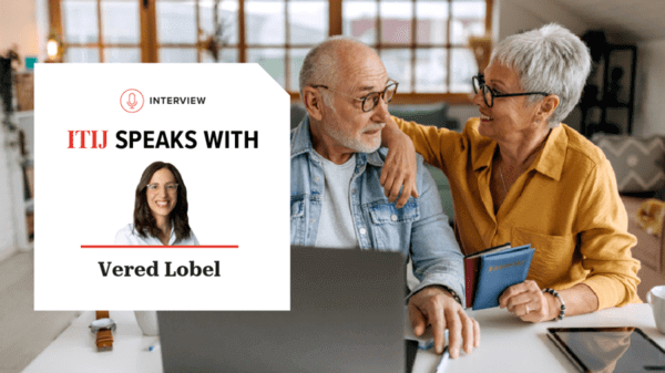 Mature couple looking at laptop with credit card