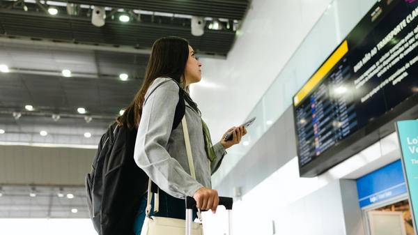 A business traveler looking at the flight board
