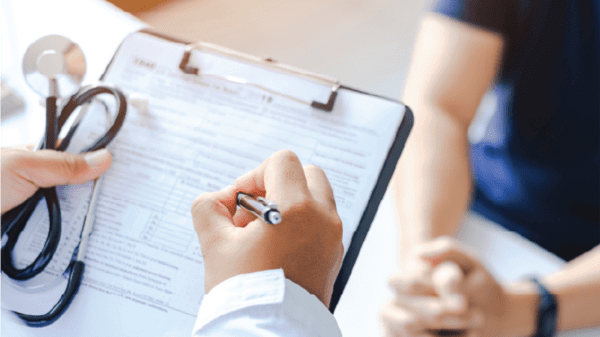 Doctor signing forms