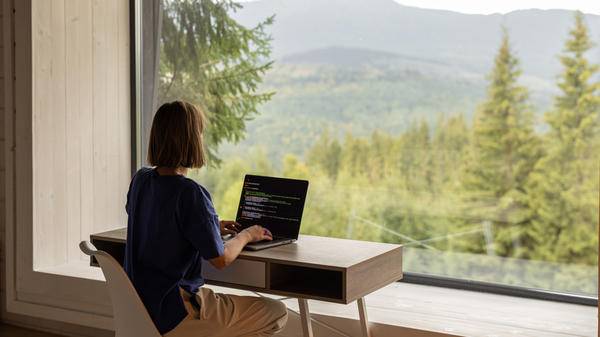 Woman sat at desk with view