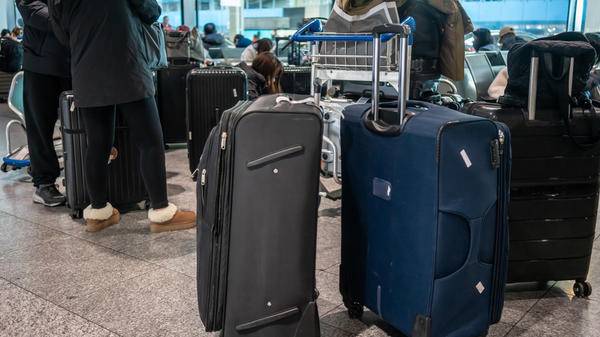 Passengers with luggage waiting at airport