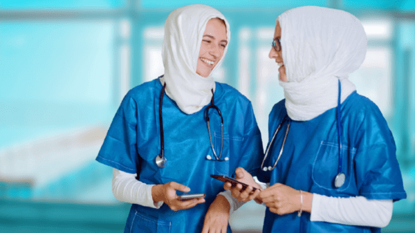 2 nurses talking and laughing with each other