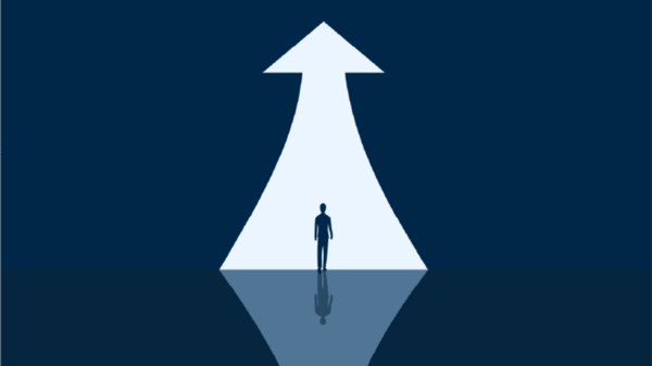 Man standing in front of an upwards arrow 