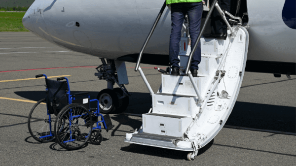 Wheelchair being carried into plane