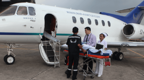 Patient carried into a plane