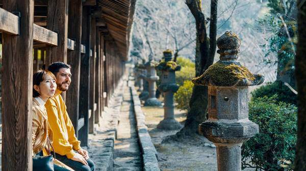 Married couple of mixed ethnicity visiting a Japanese shrine