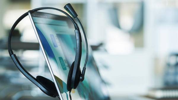 Close up headset of call center on office table, operation job concept