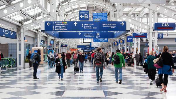 Passengers walking through Chicago O'Hare International Airport 