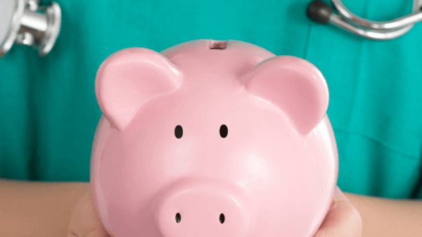 Doctor holding a piggy bank