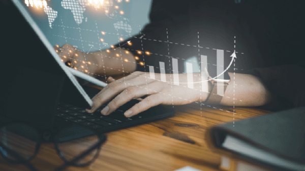 Person using laptop with graphs