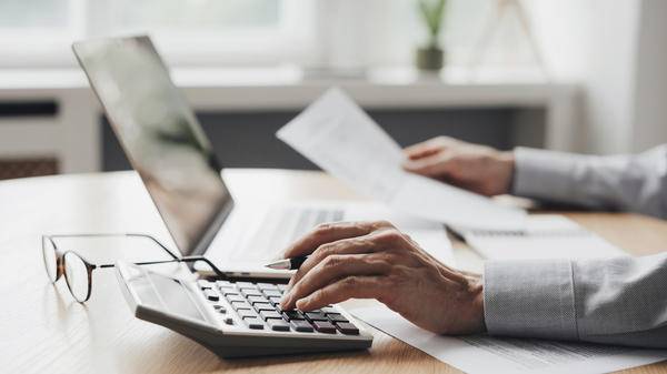 Businessman accountant, financial advisor or banker making calculations