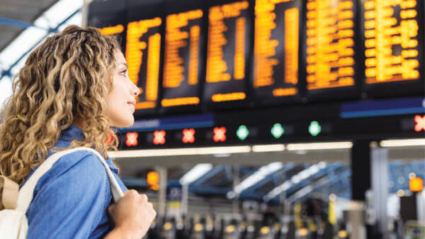 Woman looking at plane timetable