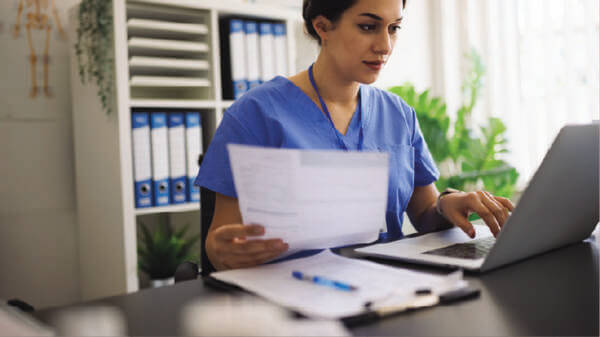 Image of doctor sat using a laptop