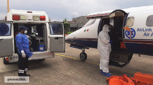 Air ambulance on a runway with an ambulance
