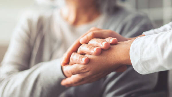 Doctor and patient holding hand