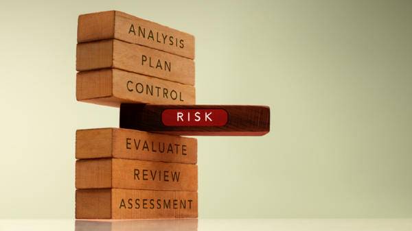 7 blocks with words inscribed on each one. 'analysis, plan, control, risk, evaluate, review, assessment'. 'risk' is sticking out 